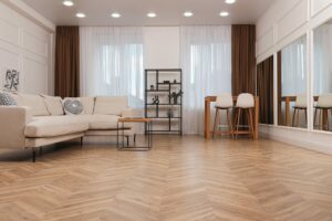 wide plank hardwood flooring in modern open concept living room with neutral furniture and natural light